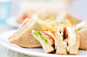 selective focus photography of plate of sliced clubhouse sandwich